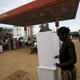 A woman casts her vote at a petrol station in Conakry.